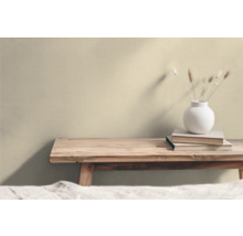 Träbänk med böcker och en vas med torkade blommor