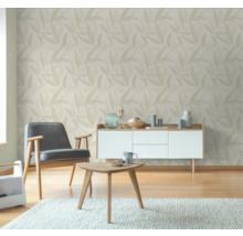 Vardagsrum med fåtöljer, soffbord, byrå och tapet med bladmönster