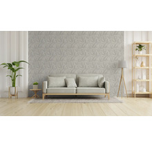 Vardagsrum med soffa, växt och hylla