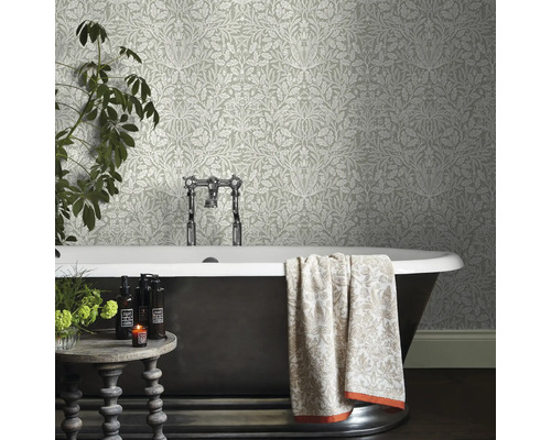 Badrum med mönstrad tapet, badkar och dekoration