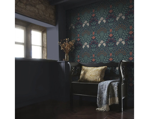 Inredningsexempel med blommönstrad tapet, bänk med kudde och överkast i ett rum med fönster