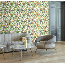 Vardagsrum med blommig tapet, soffa, fåtölj och bord