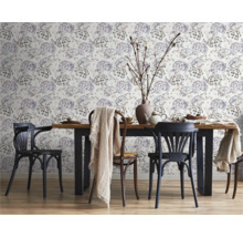 Matsal med träbord, stolar och blommigt mönstrad tapet