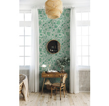 Dekorativt rum med blommig tapet, skrivbord och lampa