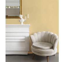 Interiörvy med fåtölj, byrå, spegel och dekorationer