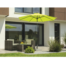 Scen med trädgårdsmöbler under ett parasoll på en terrass framför ett hus.