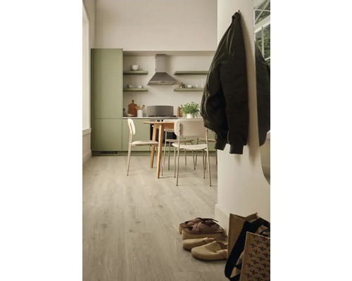 Ljust köksutrymme med matbord och stolar samt golv med träutseende