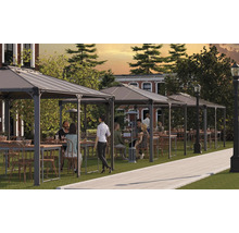 Flera paviljonger med bord och stolar på en gräsmatta för utomhusbruk.