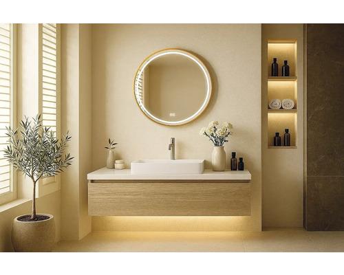 Modernt badrum med tvättställ, rund spegel och dekorativa element för en stilfull atmosfär