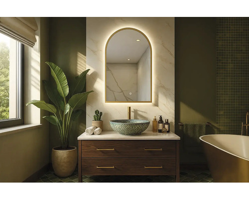 Badrum med tvättställ, spegel och växt för en ljus och rymlig atmosfär.