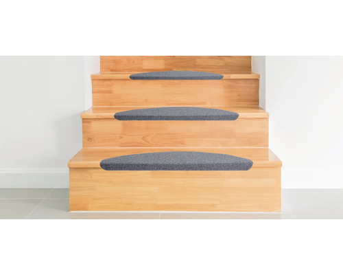 Trätrappa med grå trappstegsmattor.