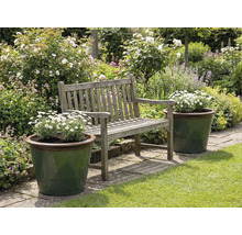 Trädgårdslandskap med träbänk och planterade blomlådor