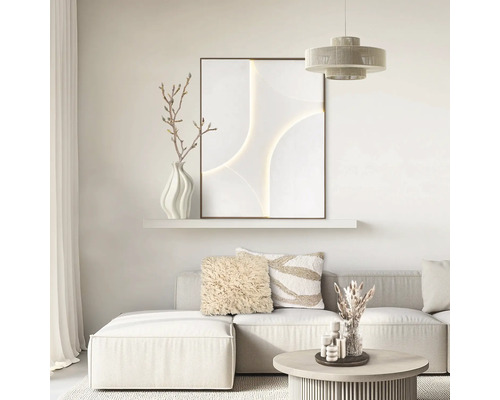 Ljust vardagsrum med modern soffa, abstrakt väggkonst på hylla, dekorationskuddar och soffbord i minimalistisk stil.