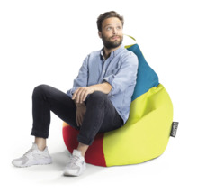 En man sitter på en färgglad sittsäck med bärhandtag och Sitting Point Logo.