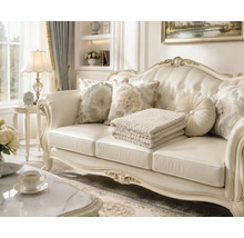 Klassisk soffa i barockstil med svängd träram och knapphäftad klädsel i ett elegant inrett vardagsrum med prydnadskuddar.
