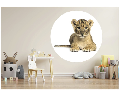 Dekorativt barnrum med bord, stol, leksaker och en väggdekal med en lejonunge