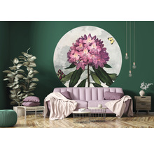 Vardagsrum med rosa soffa, soffbord, krukväxt och rund väggdekoration med blommotiv