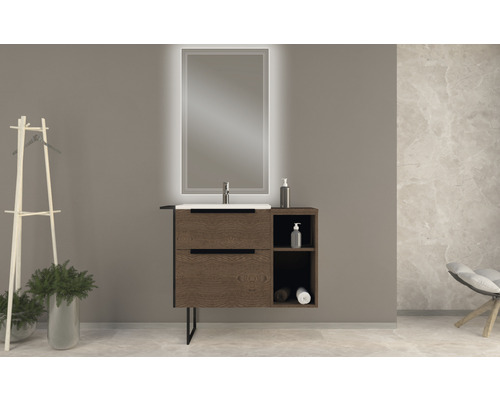 Badrum med tvättställsskåp, handfat och belyst spegel