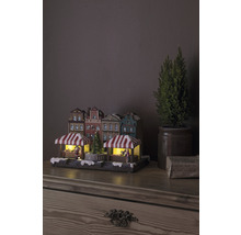 Julmarknadsby med belysning och dekorativa hus på ett bord