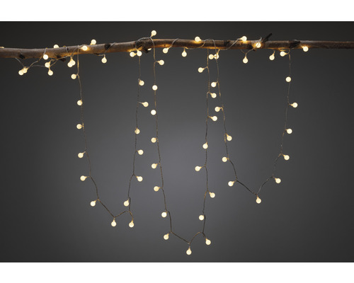 Dekorativ ljusslinga med varmvitt ljus fäst på en gren