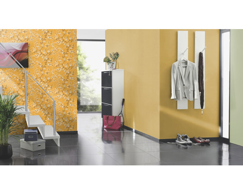 Hall med trappa, skoskåp, garderob och blommig tapet.