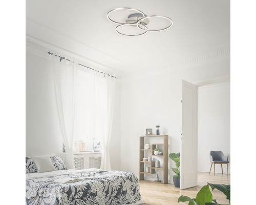 Ljust sovrum med säng och rund taklampa