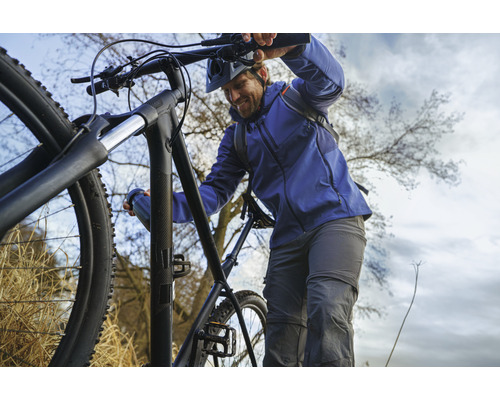 Man med mountainbike i terräng