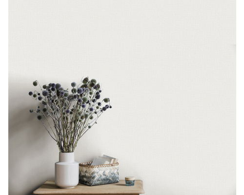 Närbild av en strukturtapet med en vas och dekoration på ett träbord