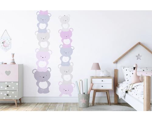 Barnrum med väggdekorationer av staplade teddybjörnar, byrå och säng