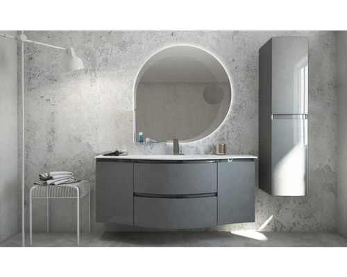 Modernt badrum med tvättställsskåp, spegelskåp och rund spegel med belysning.