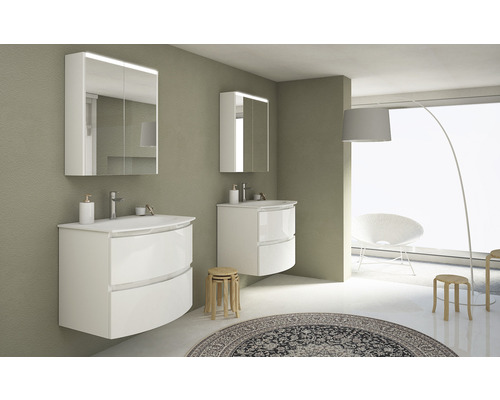 Badrum med två vita tvättställ, spegelskåp och träpallar