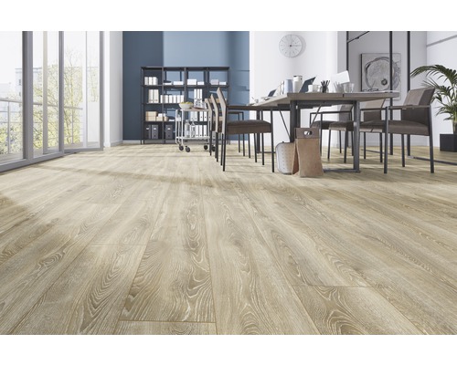 Ljust kontorsrum med trägolv, bord och stolar.