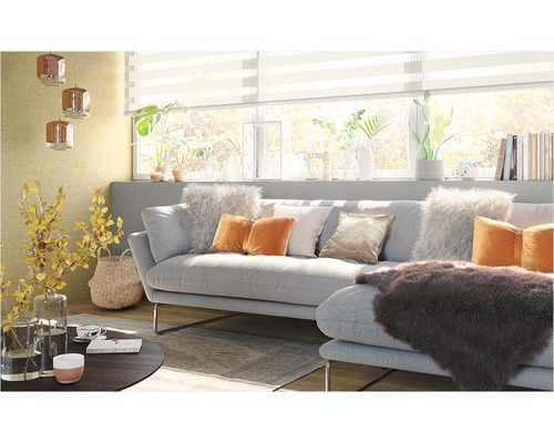 Vardagsrum med soffa, kuddar, bord och dekoration för en mysig atmosfär