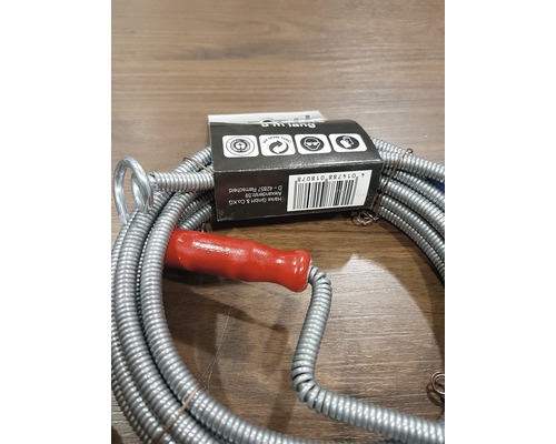 Rörrensare med rött handtag och förpackning