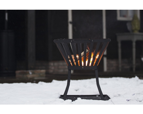 Eldkorg av metall med brinnande ved i snön