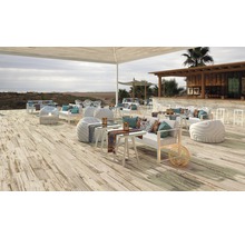 Uteplats med terrassplankor, loungemöbler och bar