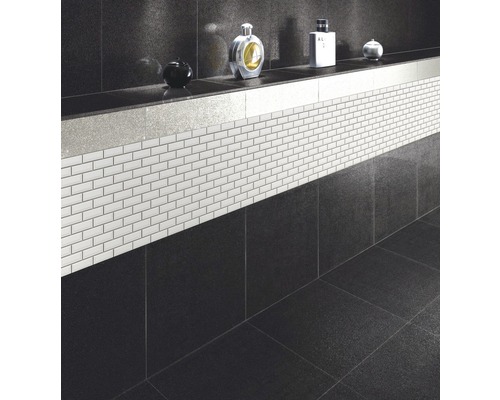 Badrum med svarta plattor och vit mosaik