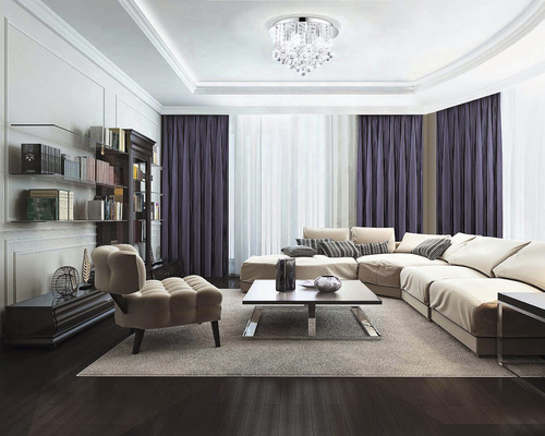 Vardagsrum med soffa, fåtölj, bokhylla och taklampa