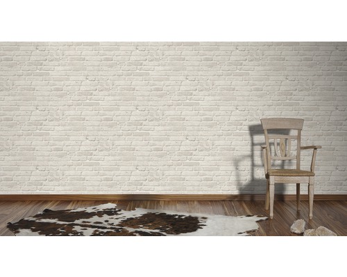 Ljust rum med tegelvägg, trägolv, matta och stol