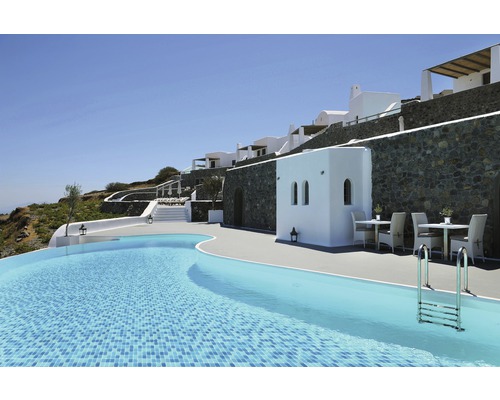 Utomhusvy av ett hotell med pool, sittplatser och vit fasad