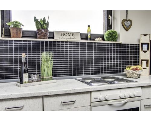 Köksscen med mosaikplattor, växter, dekorationer och elspis