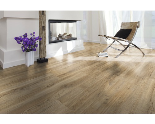 Ljust vardagsrum med laminatgolv, öppen spis, stol och dekoration