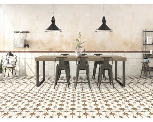 Ljust rum med matbord, stolar, kakelgolv med stjärnmönster och hänglampor