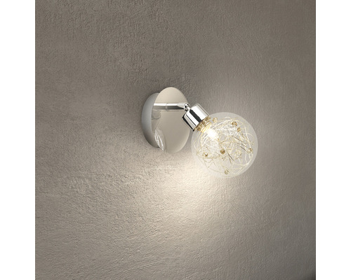 Vägglampa med runt, genomskinligt glasskydd och dekorativa element