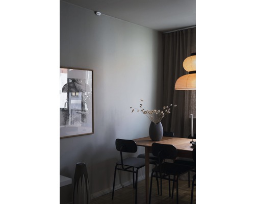 Matsal med träbord, stolar, lampa och dekoration