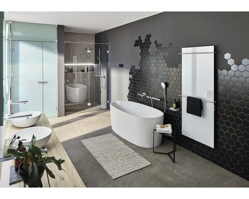 Badrum med fristående badkar, dusch, tvättställ och radiator