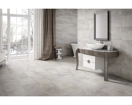 Ljust badrum med klinkergolv, tvättställsskåp och spegel