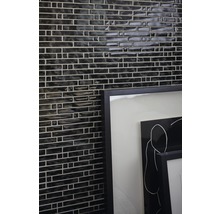 Vägg med mosaikplattor och inramad bild