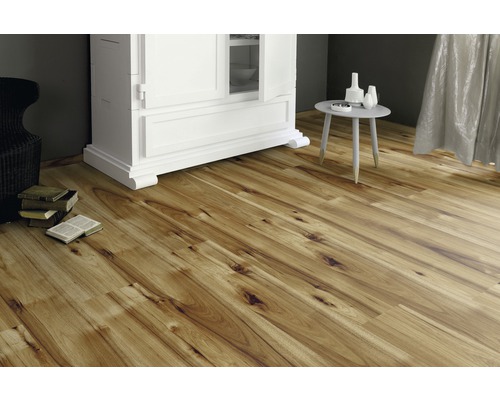 Laminatgolv lagt i ett vardagsrum med skåp och bord.