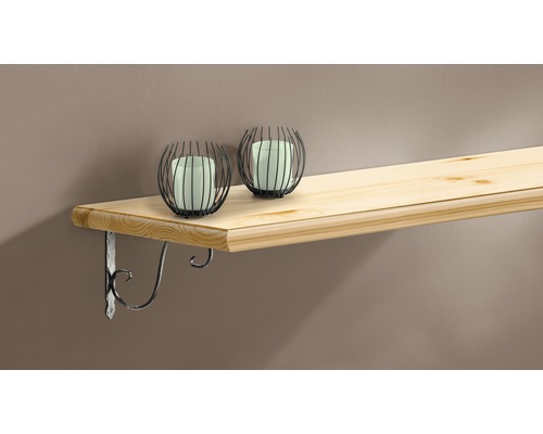 Trähylla med två dekorativa ljusstakar och ett hyllfäste